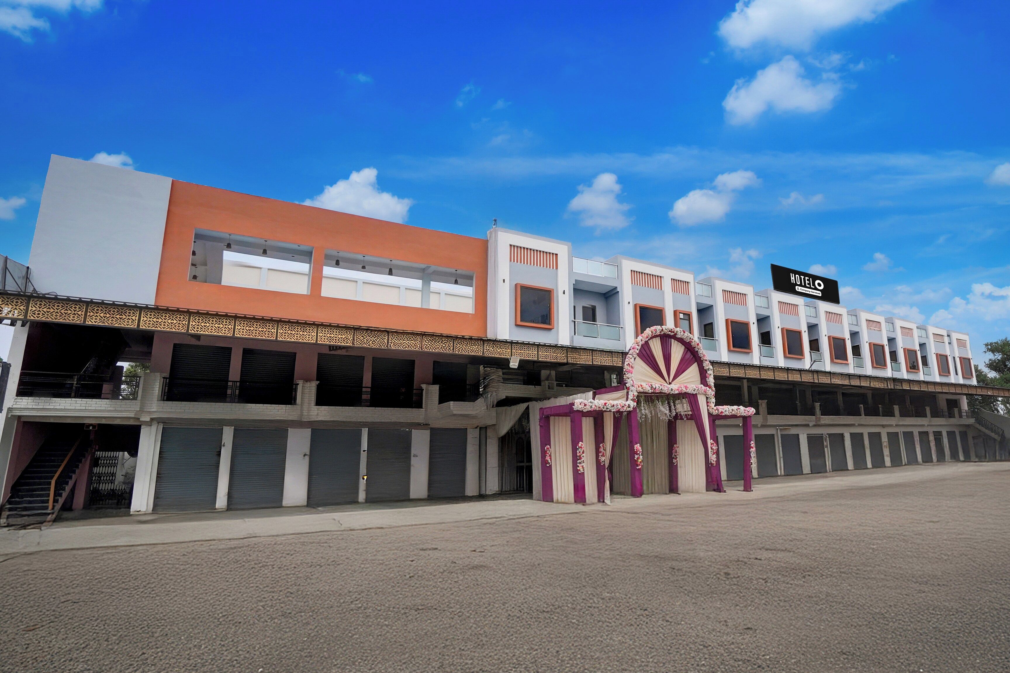 A hotel with a modern facade, multiple levels, and a prominent entrance with decorative elements.