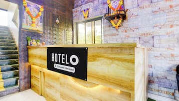 Balcão de recepção de hotel com sinalização indicando serviço corporativo.