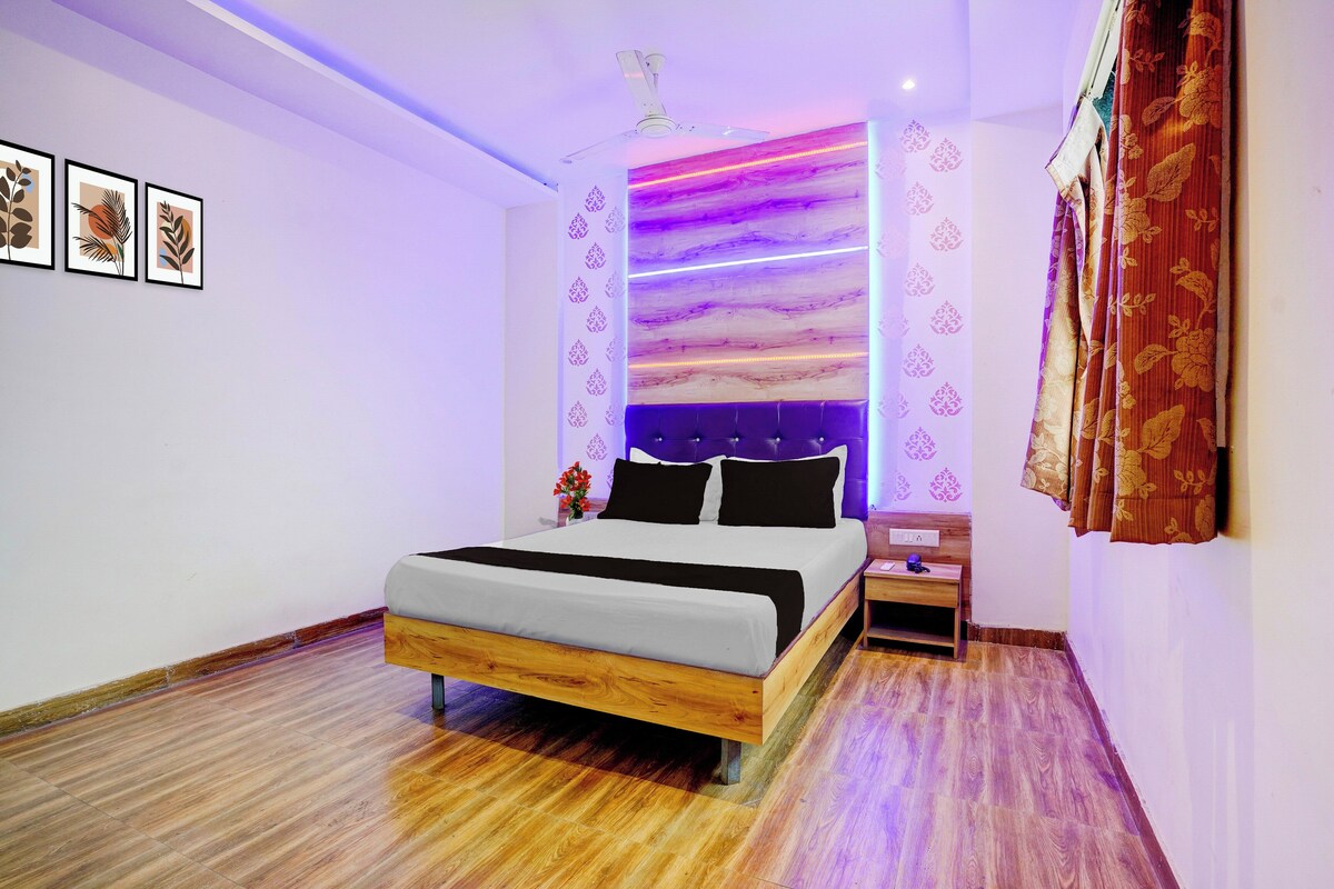A modern bedroom with a wooden bed, a nightstand, and a ceiling fan.