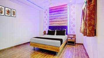 A modern bedroom with a wooden bed, a nightstand, and a ceiling fan.