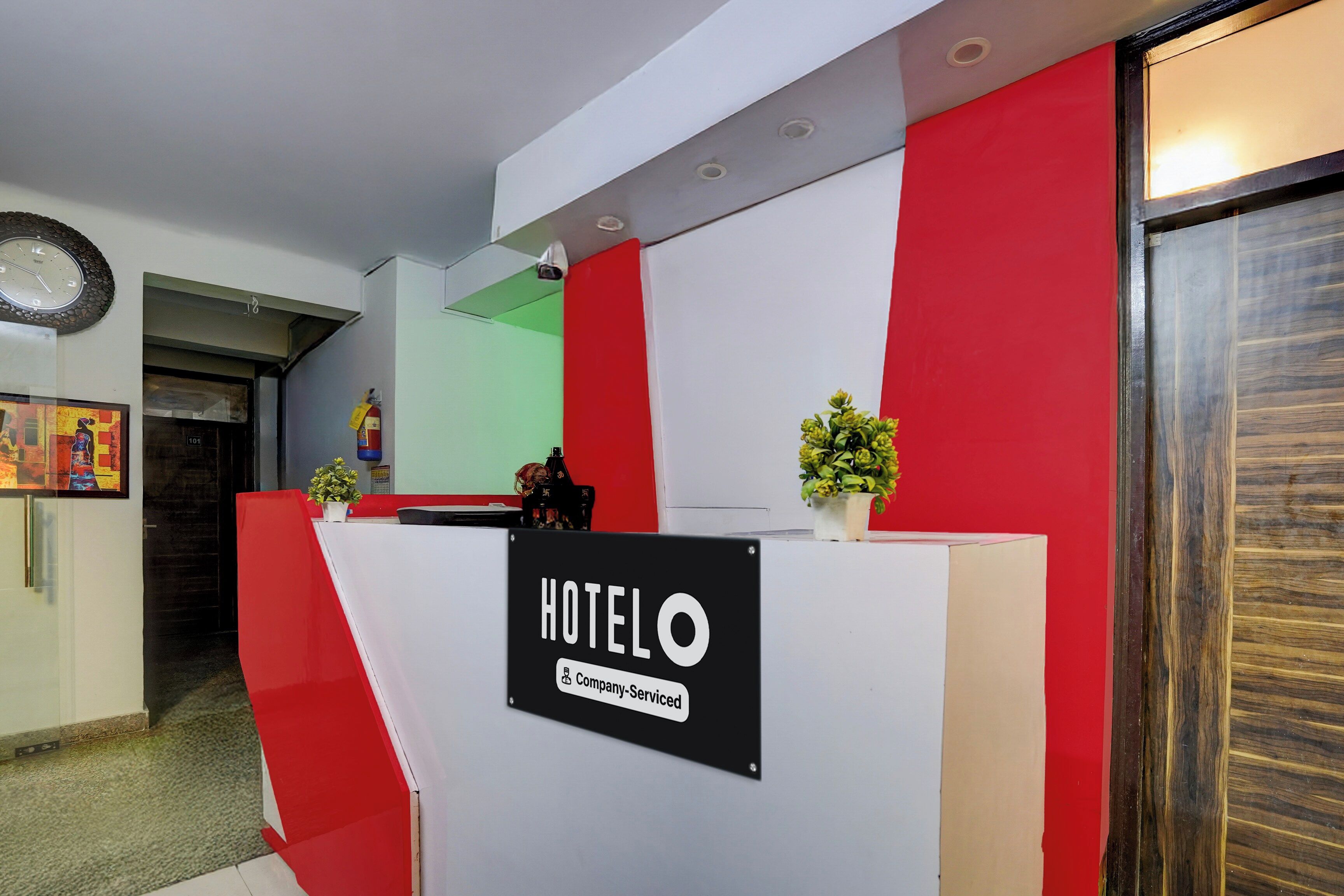 A hotel reception desk with a sign indicating it is a company-serviced hotel.