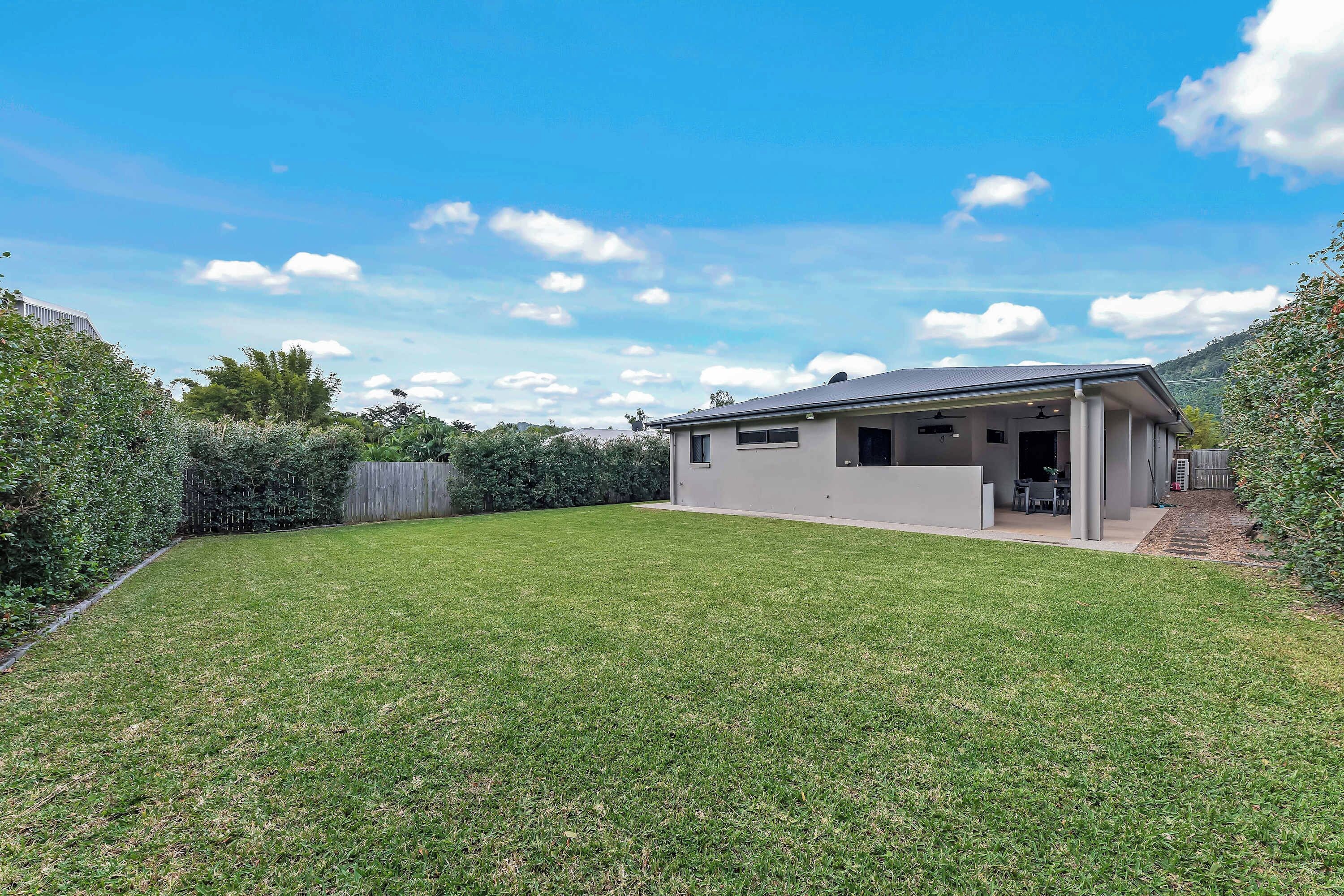Make the most of sunny afternoons in the spacious, fully fenced private backyard, where lush lawns, established greenery and mountain scenery offer plenty of room for outdoor enjoyment.