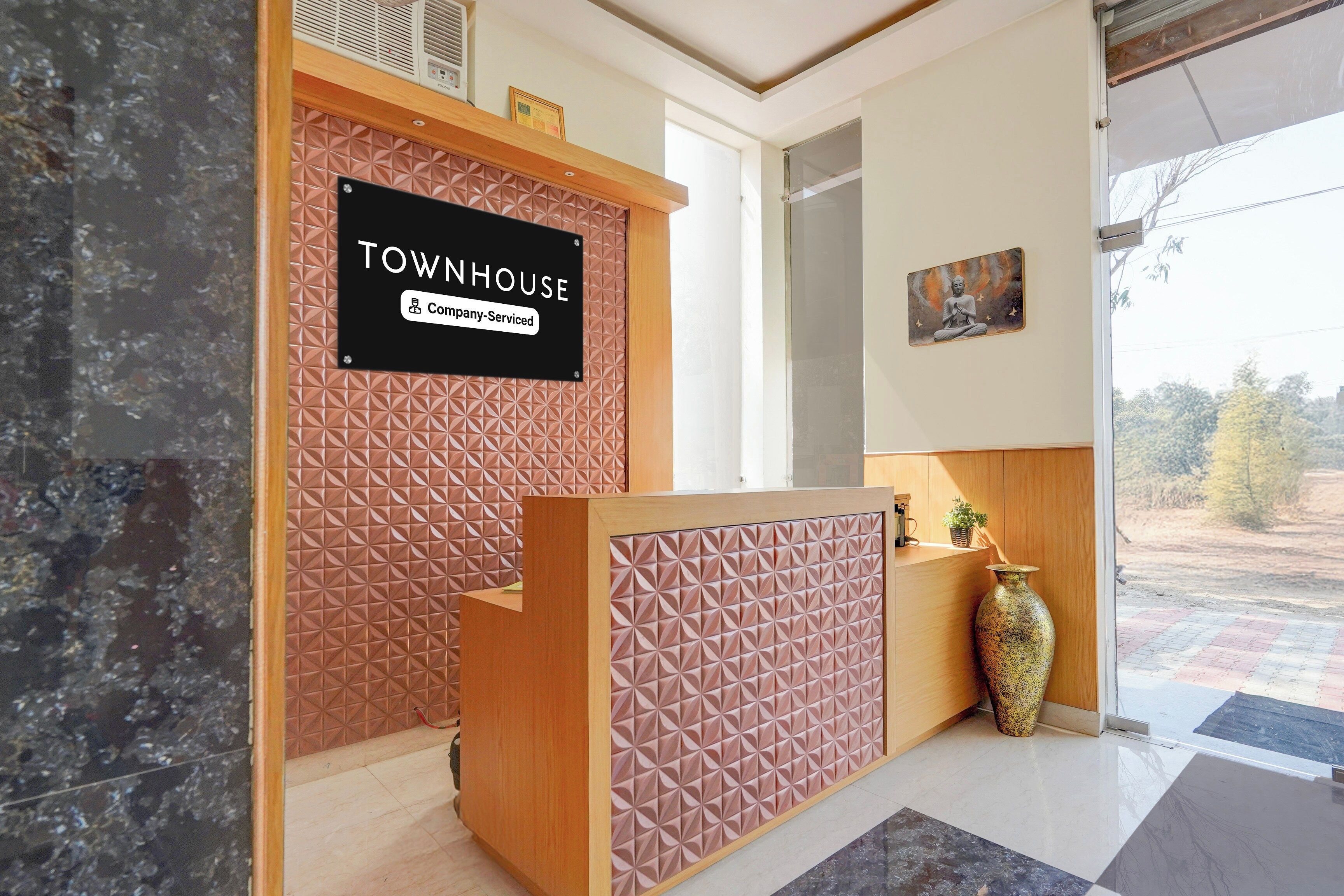 A reception desk with a sign indicating it is a company-serviced location.