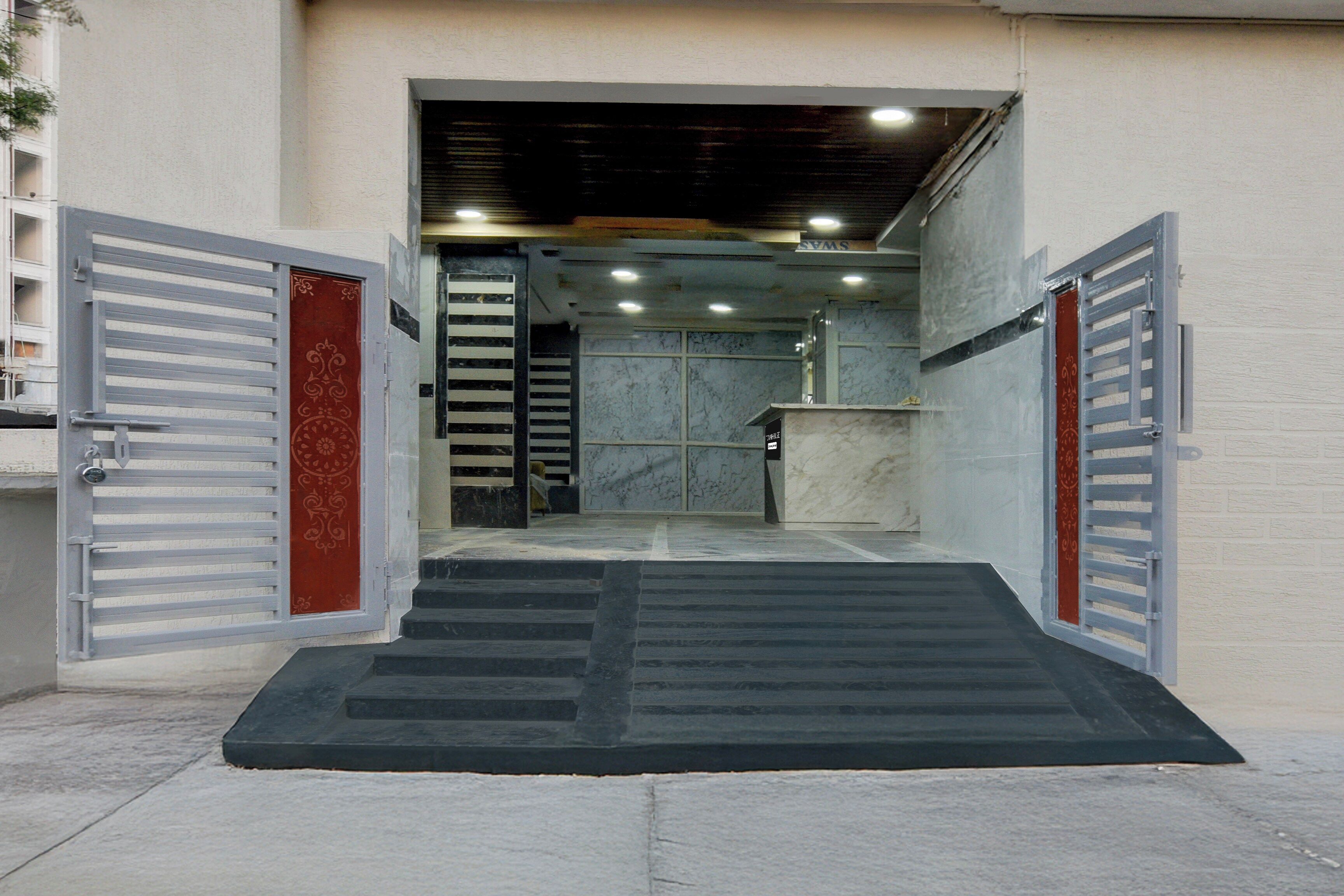 A building entrance with a ramp leading to a reception desk.