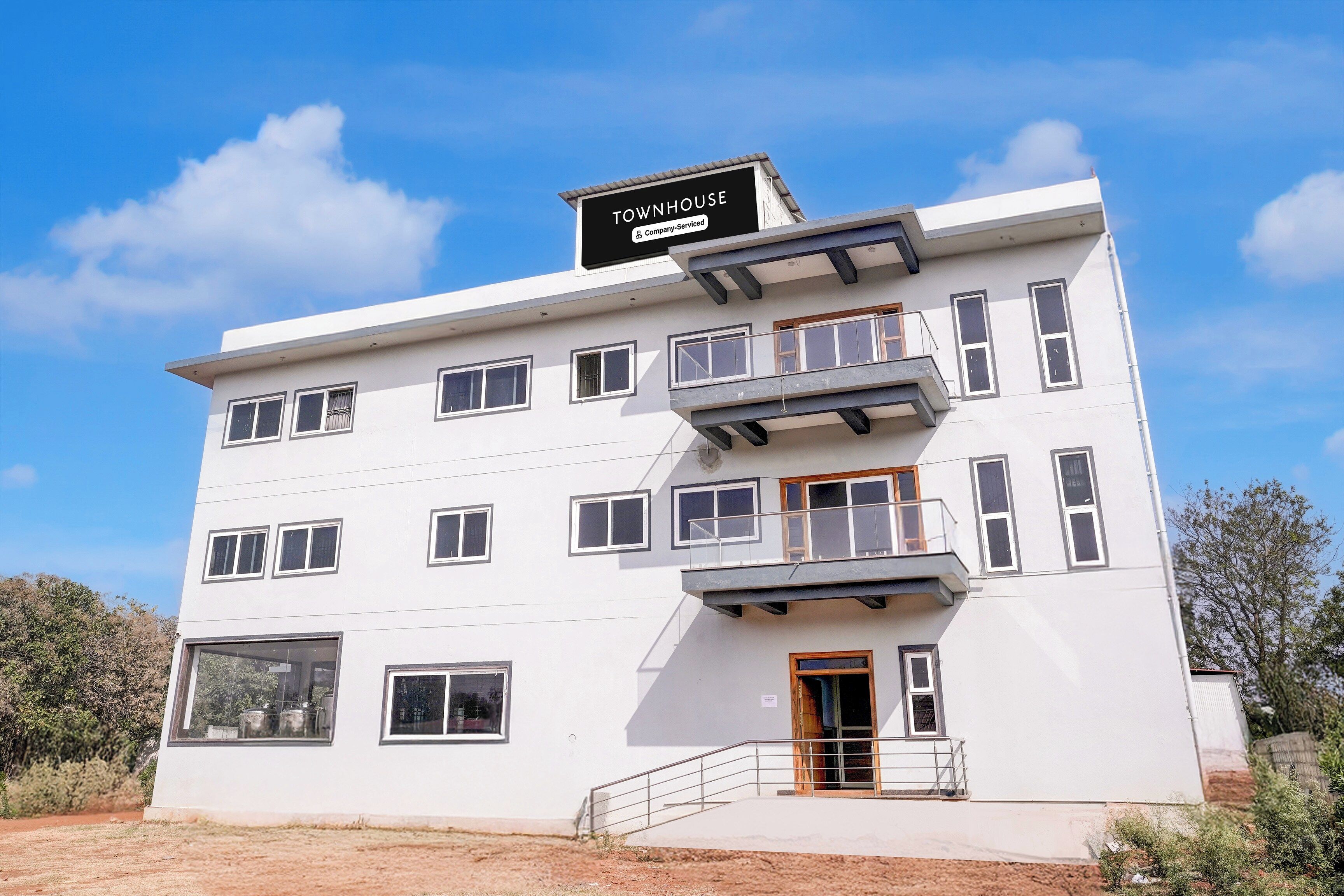 A multi-story building with a sign indicating it is a serviced company property.