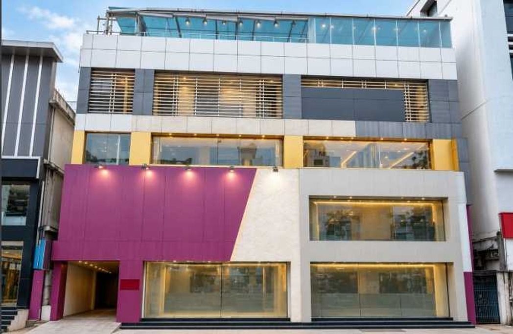 A multi-story building with large windows and a modern architectural design.