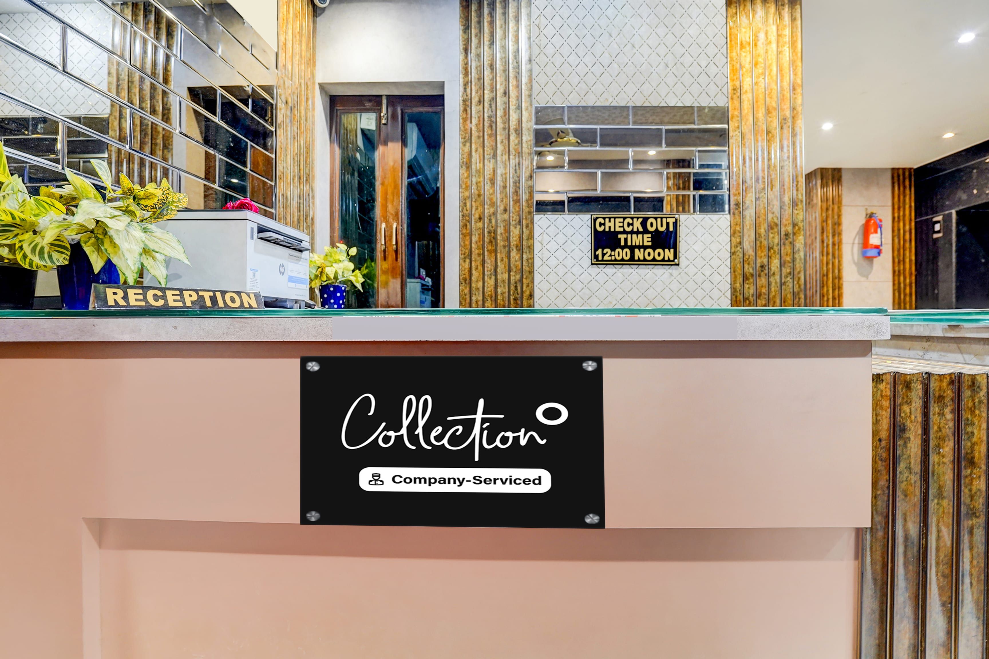 A reception desk with a sign indicating check-out time and a company-serviced label.