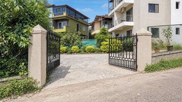 A gated entrance to a residential area with multiple apartment buildings.