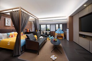 A modern hotel room with a four-poster bed, a sofa, a dining table, and a TV. - Kechuang Hotel (Shenzhen)