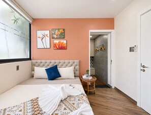 A hotel room with a bed, a window, artwork on the wall, and a door. - The Leaf Eco Villa (Thành phố Huế)
