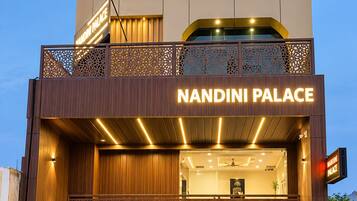 A two-story building with the sign 'NANDINI PALACE' prominently displayed.