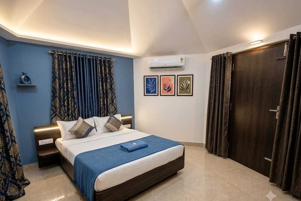 A bedroom with a bed, curtains, a wardrobe, and wall art.