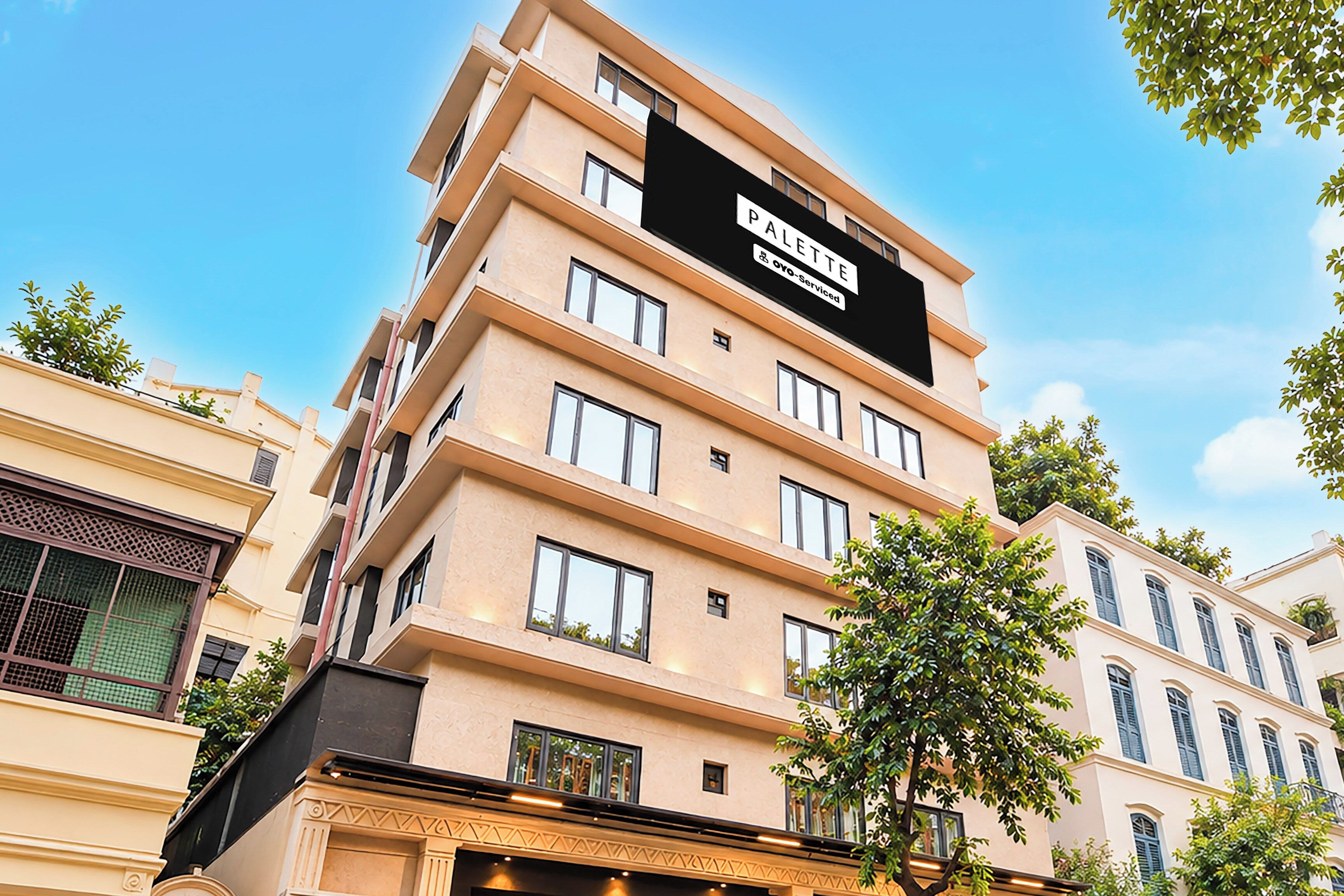A multi-story hotel building with a prominent sign indicating it is serviced by OYO.