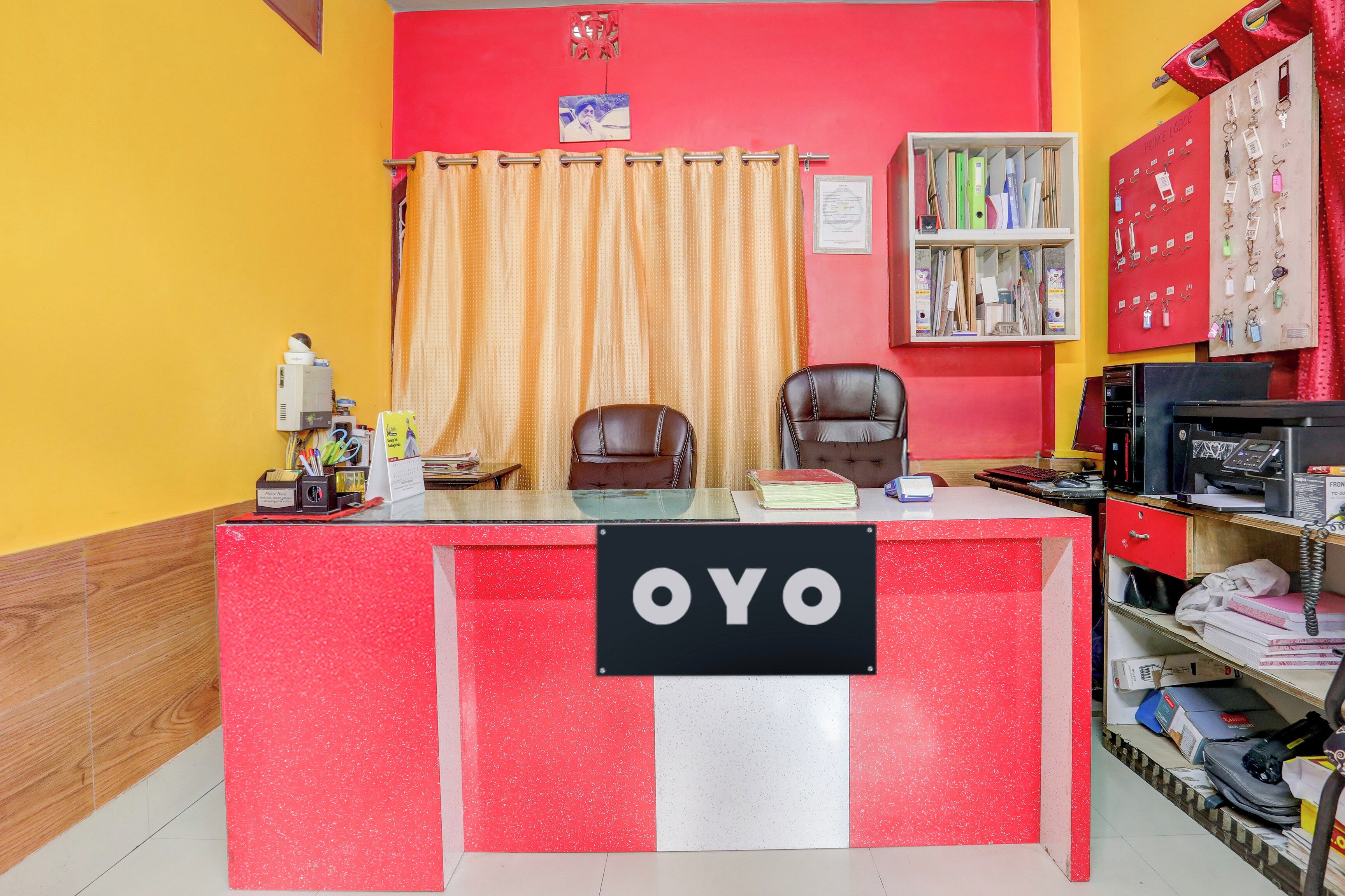 A reception desk with a sign reading 'OYO' in a hotel lobby.