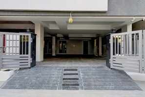 A gated entrance with a stairway leading to a covered area.