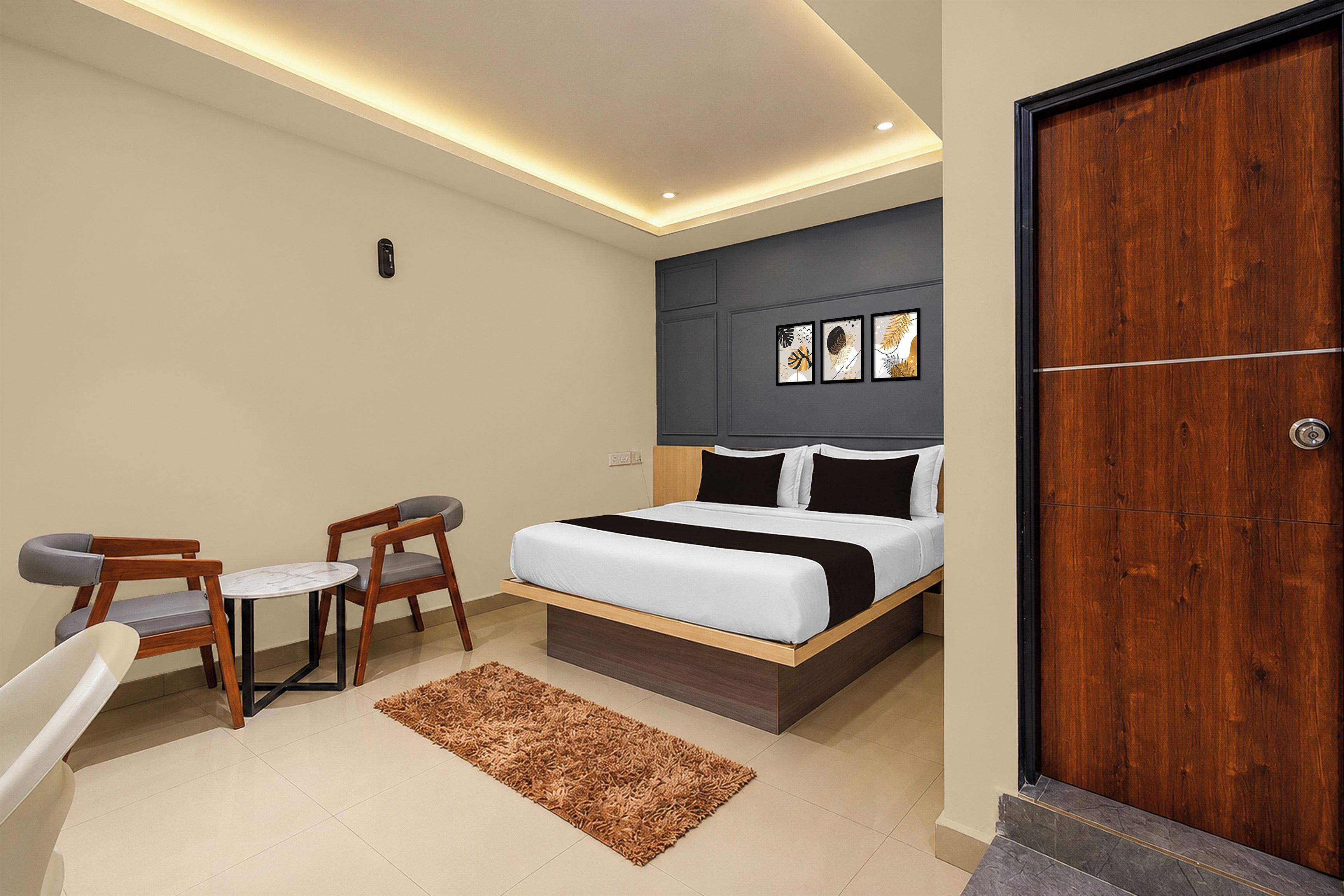 A modern bedroom with a bed, bedside tables, a chair, a rug, and a wooden door.