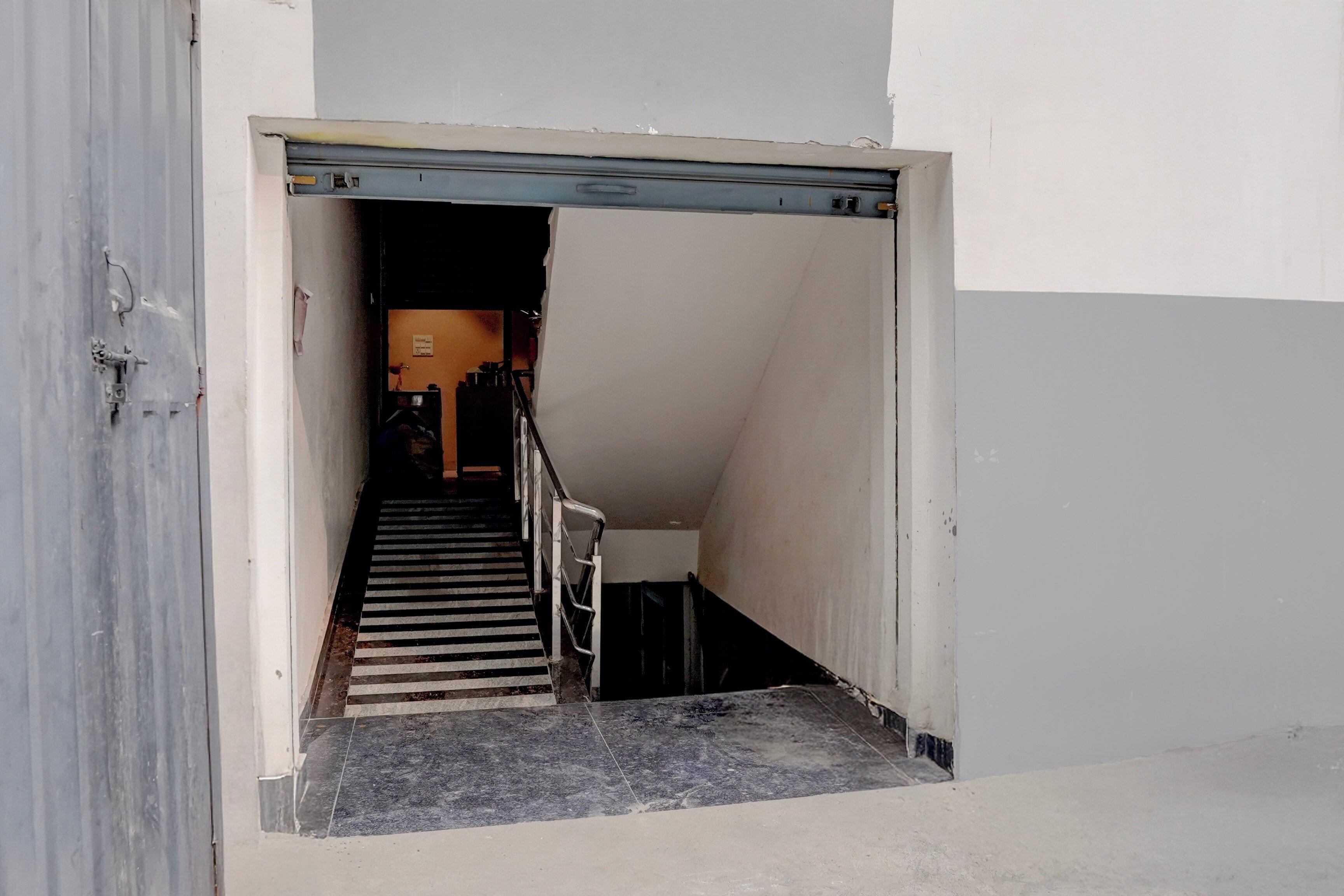A stairway leading to an upper floor with a closed door at the top.