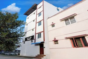 A multi-story hotel building with a sign indicating it is a hotel.