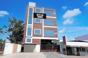 A multi-story hotel with a prominent sign reading 'HOTEL' and 'Company Serviced.'