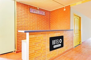 A reception desk with a sign indicating it's a company-serviced hotel.