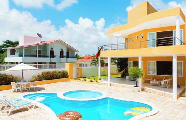 A residential property with a swimming pool, outdoor furniture, and a two-story building. - New Listing (Tamandaré)