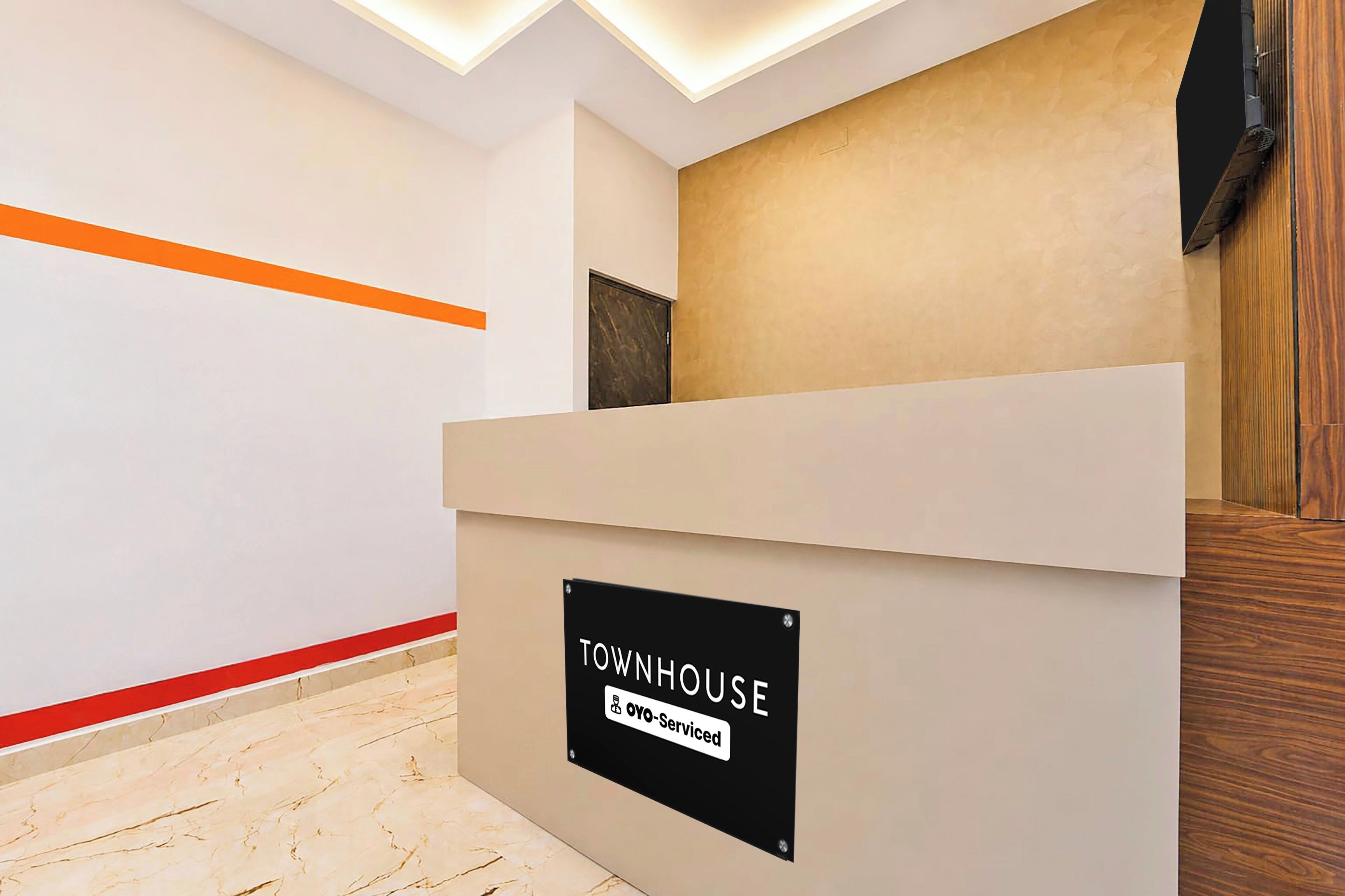 A reception desk with a sign indicating it is serviced by Oyo.