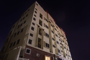 A multi-story hotel building with a prominent sign at the top.
