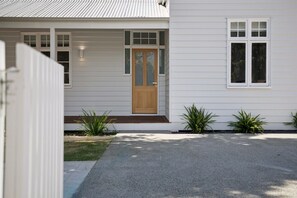A residential house with a front door, windows, and a small front yard with plants. - Three-Bed Vic Park Haven (Victoria Park)