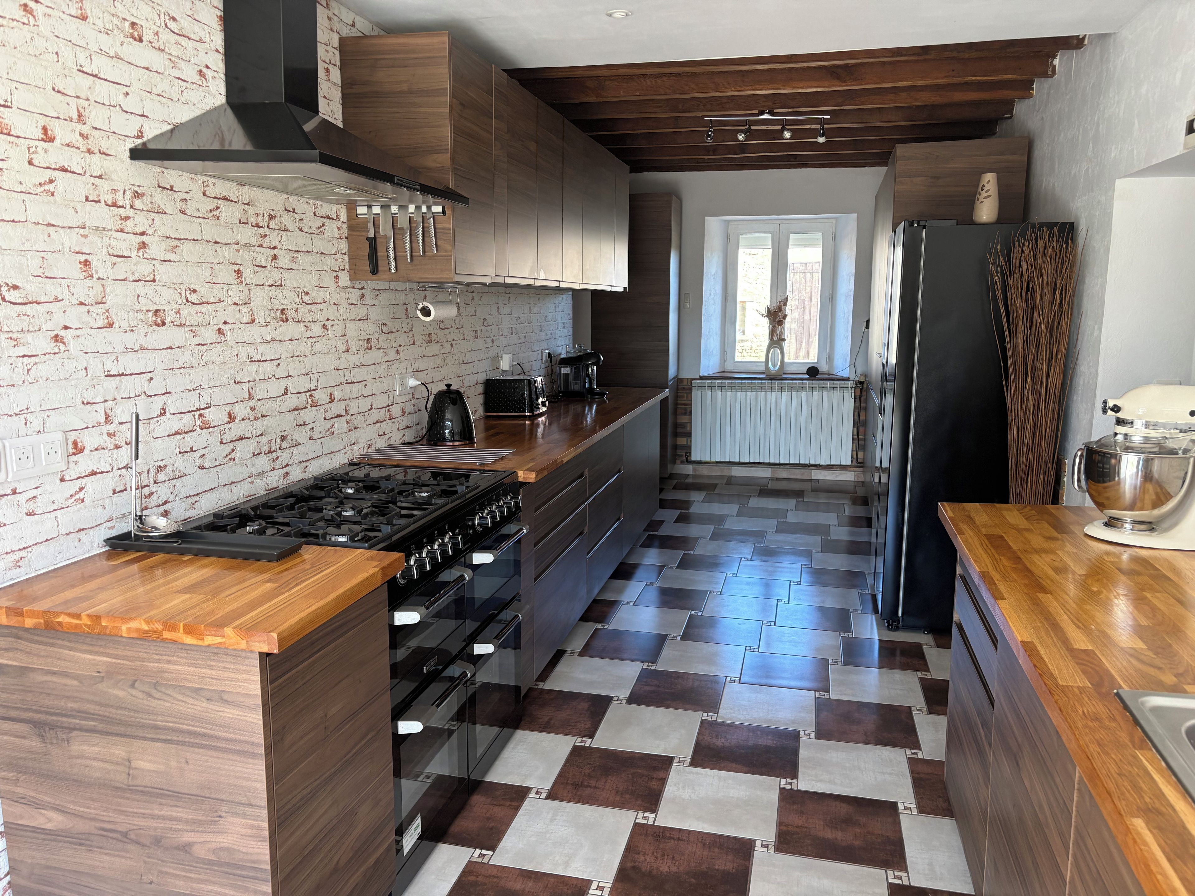 Eine moderne Küche mit Kochinsel, Herd und Kühlschrank.