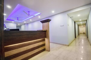 A reception desk with a modern design, a ceiling fan, and recessed lighting.