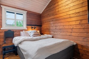 A wooden room with a bed, a window, and a nightstand. - AV47 Prime Ski-In/Ski-Out Location in Trysil (Trysil)