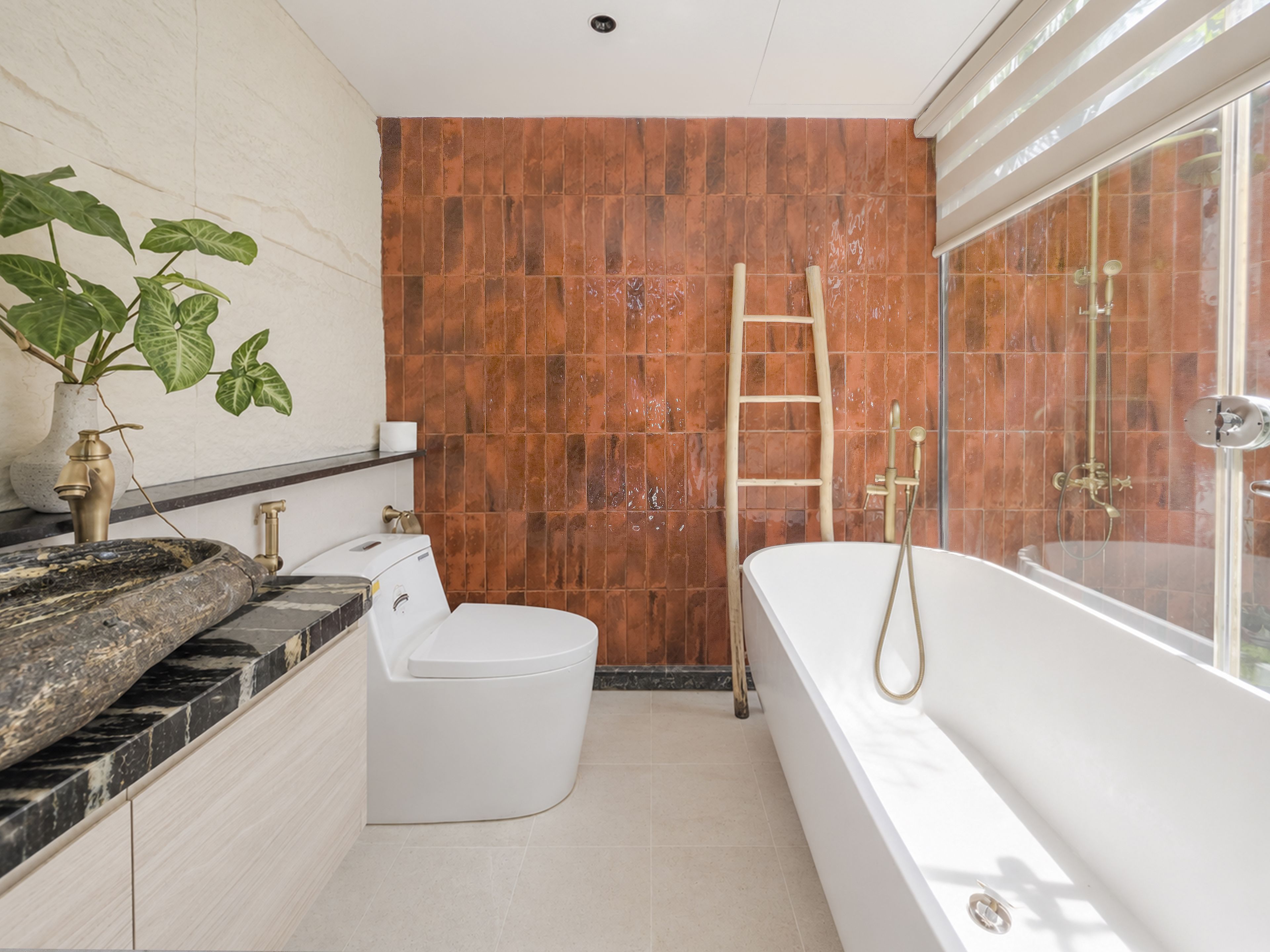 A modern bathroom with a bathtub, toilet, and sink.