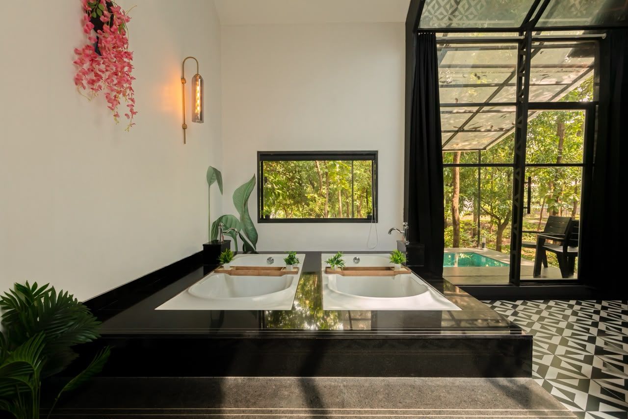 A bathroom with a large window, two sinks, and a view of a pool.