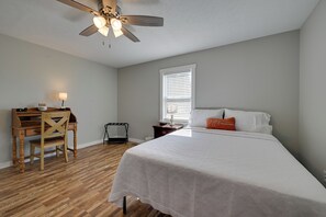 A bedroom with a bed, a desk, a chair, a ceiling fan, and a window with blinds. - Fishing Pond! Quiet, Renovated Family Farmhouse! (Brownsville)