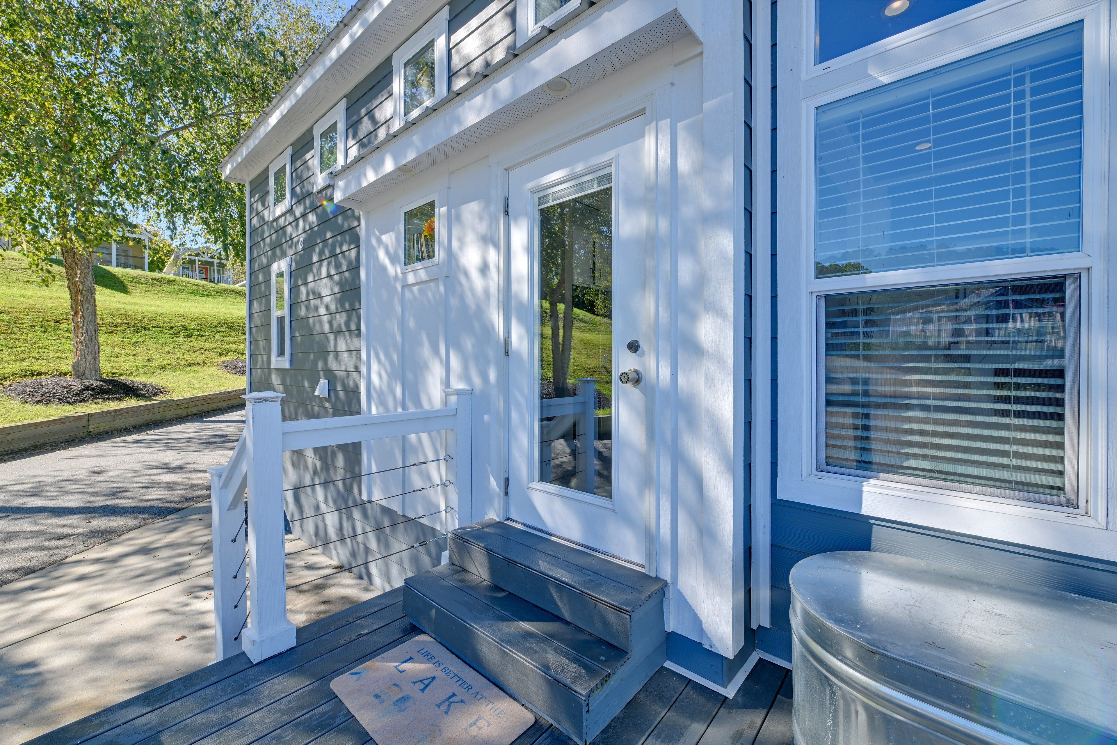 A house with a front porch, a set of stairs leading to the entrance, and a mailbox.