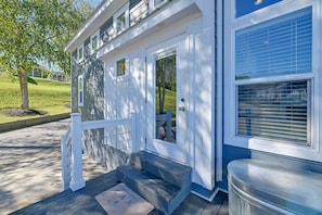 A house with a front porch, a set of stairs leading to the entrance, and a mailbox.