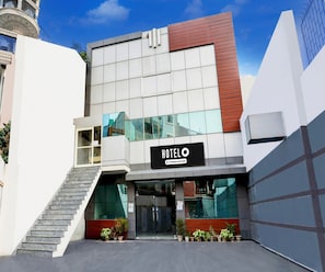 A modern hotel building with a sign indicating it is company-serviced. - Classic Maharaja Grand (New Delhi)