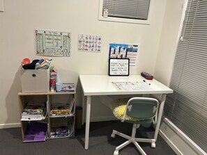 A study area with a desk, chair, and shelves containing books and supplies. - Spacious 3-Bedroom House Rental in Waterford, Australia (Waterford)