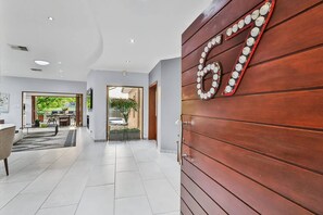 A modern hotel lobby with a wooden wall and a large number 67 sign. - Luxurious 4-Bedroom Villa with Private Pool in Hartbeespoort (Hartbeespoort)