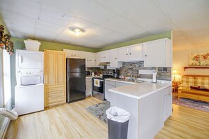 A kitchen with white cabinets, a refrigerator, a microwave, and a coffee maker. - Historic Welch Retreat! Ride, Hike & Explore (Welch)