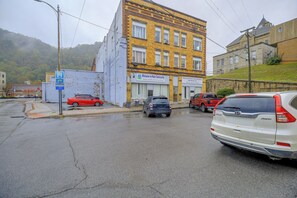 A street view with a building labeled 'Welcome to Nain Community' and a parking lot with several cars. - Historic Welch Retreat! Ride, Hike & Explore (Welch)