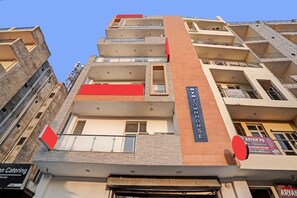 A multi-story building with a prominent 'OYO TOWNHOUSE' sign. - Signature Hotel Noida-62 (Noida)