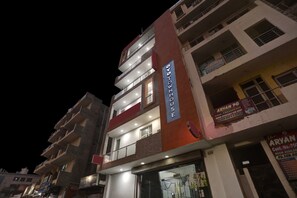 A multi-story building with a prominent sign for 'The Aryan PG' indicating a property for rent. - Signature Hotel Noida-62 (Noida)