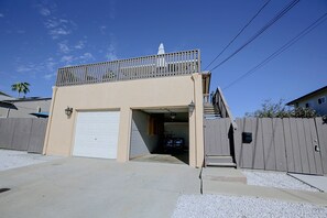 A two-story building with a garage, a balcony, and a fenced area. - Chic Apt < 5 Mi to SDSU! Private Patio & Views (La Mesa)