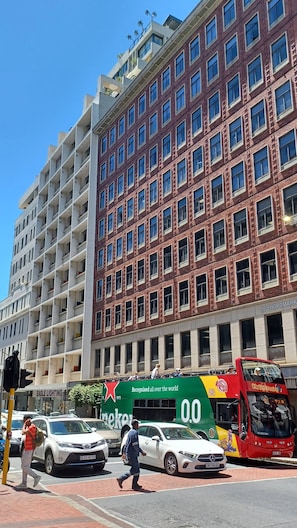 A multi-story building with a mix of brick and white facade, large windows, and a visible street-level entrance. - Manhattan Feeling! 2BR, Huge Terrace & Epic Views, 2min walk Bree Street (Cape Town)