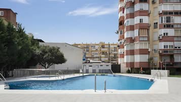 A swimming pool surrounded by apartment buildings.