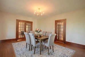 A dining room with a wooden table, six chairs, a chandelier, and a floral centerpiece. - 1 Mi to Culver-Stockton College: Home w/ Yard (Canton)