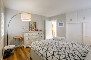 A bedroom with a bed, dresser, lamp, and artwork. - Pet-Friendly Central Home w/ Fenced Yard! (San Diego)