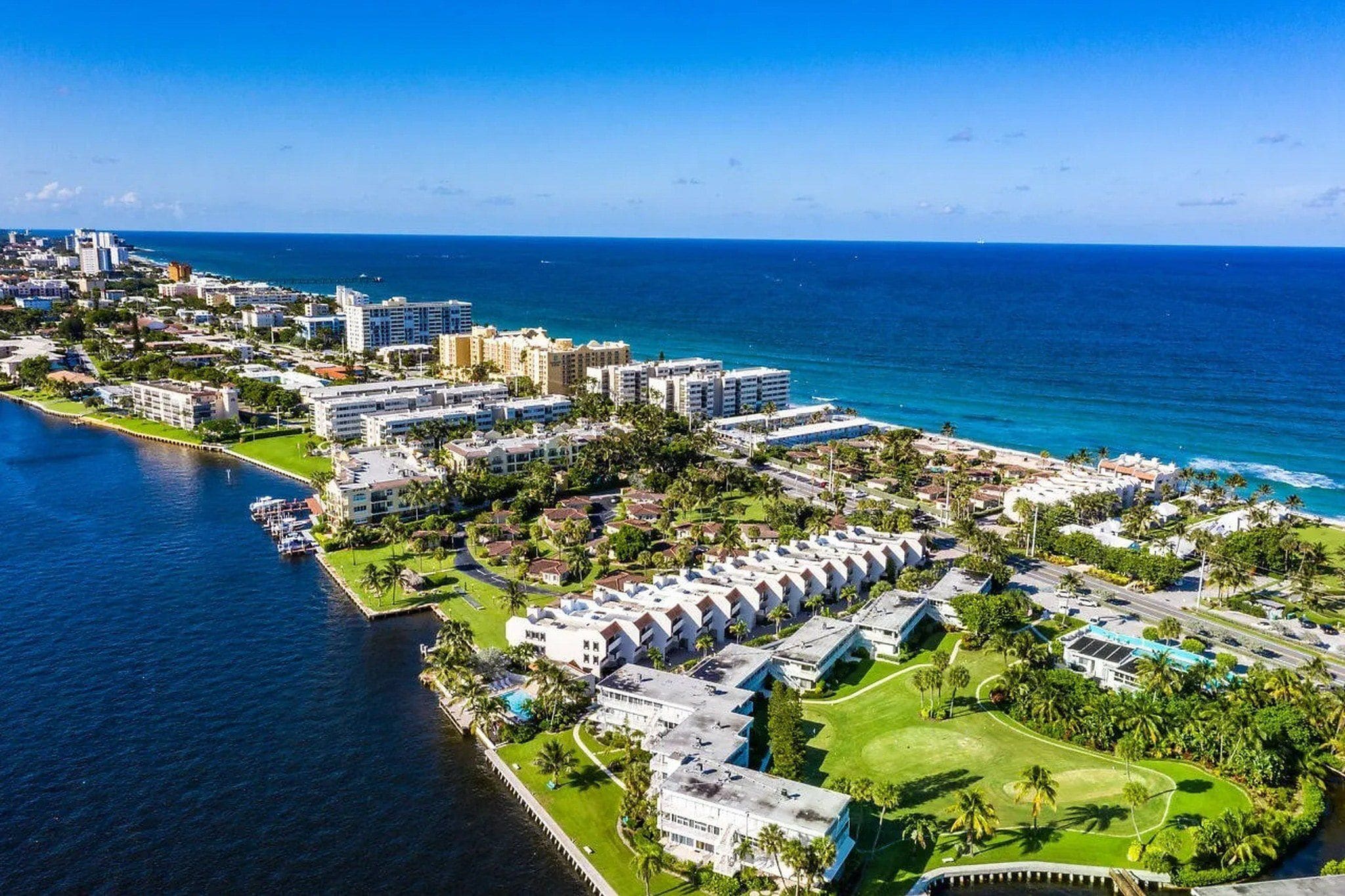 A coastal resort with beachfront villas, a marina, and a golf course.