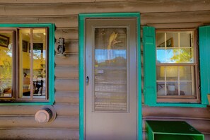 A log cabin with a front door, two windows with green shutters, and a small porch area. - Rustic Cabin-Stunning View-Cov Porch<br>Delaware Gem! (Damascus)